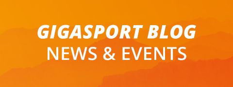 Fondo naranja con siluetas de montañas. Texto blanco dice "GIGASPORT BLOG NOTICIAS Y EVENTOS".