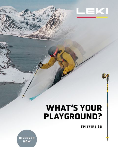 Un esquiador con chaqueta amarilla y gafas de esquí desciende una ladera nevada con bastones. En el fondo se ven montañas nevadas y un lago. El texto dice "¿CUÁL ES TU CAMPO DE JUEGO? SPITFIRE 3D" con un botón de "DESCUBRE AHORA".