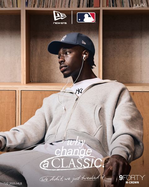 Un hombre con un chándal gris y una gorra de los New York Yankees está sentado relajado escuchando música con auriculares. La marca de New Era, MLB y 9FORTY M-CROWN es visible, con el texto "¿Por qué cambiar un clásico?" a través de la imagen.