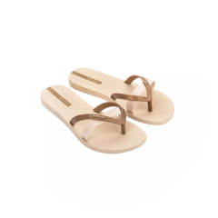 Un par de sandalias tipo chancla de color beige con tiras marrones y rosa claro sobre un fondo blanco y circular.